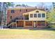 Large backyard with a patio, deck, and mature trees surrounding the property at 3970 Brenteresa Ct, Snellville, GA 30039