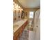 Cozy bathroom featuring double sinks, a toilet, and shower with patterned curtain at 3970 Brenteresa Ct, Snellville, GA 30039