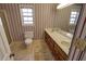 Bathroom with striped wallpaper, dual vanity, and tiled floor at 3970 Brenteresa Ct, Snellville, GA 30039