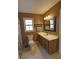 Bathroom with decorative tile floor, large vanity, framed mirror, and a window for natural light at 3970 Brenteresa Ct, Snellville, GA 30039
