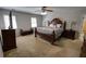 Bedroom featuring a large bed, bench, side tables, and a ceiling fan at 3970 Brenteresa Ct, Snellville, GA 30039