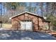 Detached brick garage with a fenced area, ideal for secure parking and storage at 3970 Brenteresa Ct, Snellville, GA 30039