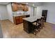 Kitchen with a central island, seating, stainless steel appliances, and wood cabinetry at 3970 Brenteresa Ct, Snellville, GA 30039