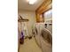 This laundry room includes a washer, dryer, cabinets and a window at 3970 Brenteresa Ct, Snellville, GA 30039