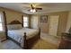 This is a spacious bedroom with a ceiling fan and a large wooden bed at 3970 Brenteresa Ct, Snellville, GA 30039