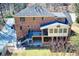 Expansive brick home featuring a sunroom, deck, and walkout basement overlooking a lush backyard at 3970 Brenteresa Ct, Snellville, GA 30039