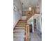 Entryway showcasing a carpeted staircase with wooden banisters and tiled floor at 3970 Brenteresa Ct, Snellville, GA 30039