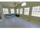 Bright sunroom with tiled floors, many windows, and a hammock at 3970 Brenteresa Ct, Snellville, GA 30039