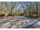 Entrance to River Run, with signs and mature trees along the paved road at 408 River Run Dr, Atlanta, GA 30350
