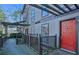 Townhouse exterior with wood siding, a red front door, and a covered porch at 408 River Run Dr, Atlanta, GA 30350