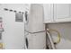 Laundry room with stacked washer and dryer and storage space at 408 River Run Dr, Atlanta, GA 30350