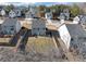 Overhead view of a house with a fenced yard, a neighborhood, and trees at 7104 Skippingstone Way, Douglasville, GA 30134