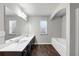Bright bathroom with a double sink vanity, soaking tub, shower, and natural light from two windows at 7104 Skippingstone Way, Douglasville, GA 30134