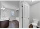 Bathroom featuring a double sink vanity, toilet, soaking tub, shower, and natural light from the window at 7104 Skippingstone Way, Douglasville, GA 30134