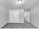 A cozy bedroom featuring gray walls, plush carpeting and a double door closet at 7104 Skippingstone Way, Douglasville, GA 30134