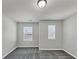 Bright bedroom with plush carpet and two windows providing natural light, offering a serene and inviting space at 7104 Skippingstone Way, Douglasville, GA 30134