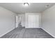 Bright bedroom featuring plush carpet and a closet with double doors, creating a serene and inviting space at 7104 Skippingstone Way, Douglasville, GA 30134