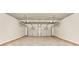 A clean two car garage space with white walls and a concrete floor at 7104 Skippingstone Way, Douglasville, GA 30134