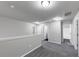 Upstairs hallway features plush gray carpeting and access to bedrooms and bathroom at 7104 Skippingstone Way, Douglasville, GA 30134