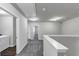 Upstairs hallway featuring plush gray carpeting, white trim and access to laundry and bedrooms at 7104 Skippingstone Way, Douglasville, GA 30134