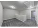 Spacious hallway featuring plush gray carpet, neutral walls, and access to bedrooms at 7104 Skippingstone Way, Douglasville, GA 30134