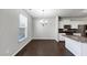 Open-concept kitchen and dining area with stainless steel appliances and dark wood floors at 7104 Skippingstone Way, Douglasville, GA 30134