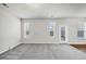 Inviting living room with multiple windows and plush carpeting at 7104 Skippingstone Way, Douglasville, GA 30134