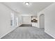 Open-concept living room with carpeting and access to the kitchen at 7104 Skippingstone Way, Douglasville, GA 30134
