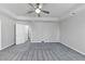 Spacious main bedroom with tray ceiling, plush carpet and neutral walls at 7104 Skippingstone Way, Douglasville, GA 30134
