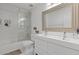 Modern bathroom featuring dual sinks and a tiled shower at 7382 Gossamer St, Union City, GA 30291