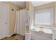 Relaxing bathroom with a soaking tub beneath a window at 7382 Gossamer St, Union City, GA 30291