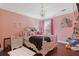 Cozy pink bedroom with a chandelier and dark wood floors at 7382 Gossamer St, Union City, GA 30291