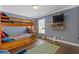 Bedroom featuring a bunk bed, dark wood floors, and large window at 7382 Gossamer St, Union City, GA 30291