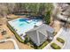Aerial view of community pool and playground, with lounge chairs and umbrellas at 7382 Gossamer St, Union City, GA 30291