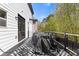Back deck features a black and white rug and access to the yard at 7382 Gossamer St, Union City, GA 30291