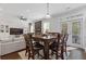 Open-concept dining area adjacent to the living room, featuring a wooden dining table with seating for eight at 7382 Gossamer St, Union City, GA 30291