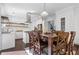 Bright dining room with hardwood floors, modern lighting, and seating for six at 7382 Gossamer St, Union City, GA 30291