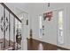 Bright foyer features hardwood floors, staircase with iron railings, and a stylish front door with sidelights at 7382 Gossamer St, Union City, GA 30291