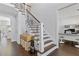 Elegant foyer with hardwood floors, a staircase with decorative iron railings, and a glimpse of the office at 7382 Gossamer St, Union City, GA 30291