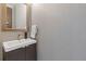 Modern half bath with dark wood vanity, and designer wallpaper at 7382 Gossamer St, Union City, GA 30291