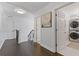 Bright hallway boasts wood floors, white walls, and laundry room access at 7382 Gossamer St, Union City, GA 30291