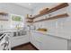 Bright and sleek kitchen with open shelving, modern fixtures, and stainless steel sink at 7382 Gossamer St, Union City, GA 30291