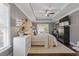 Main bedroom featuring tray ceiling, sitting area, wood floors, and large windows at 7382 Gossamer St, Union City, GA 30291