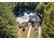 Aerial view of community pool and amenity center surrounded by landscaping and mature trees at 1026 Wellesley Crest Dr, Woodstock, GA 30189