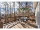 Wooden deck with a table, chairs, and a chiminea, perfect for relaxing outdoors at 1026 Wellesley Crest Dr, Woodstock, GA 30189