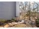 The backyard has a gentle slope with landscaping and stone accents at 1026 Wellesley Crest Dr, Woodstock, GA 30189