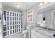 Bathroom with shower, tub, single sink with a white marble countertop at 1026 Wellesley Crest Dr, Woodstock, GA 30189