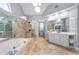 A luxurious bathroom features a glass shower, tub, and double sink at 1026 Wellesley Crest Dr, Woodstock, GA 30189