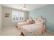 This bedroom has two twin-sized beds, light blue accent wall, and ceiling fan at 1026 Wellesley Crest Dr, Woodstock, GA 30189