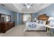 Bedroom featuring a light blue painted wall, a bed, windows, and a wooden dresser at 1026 Wellesley Crest Dr, Woodstock, GA 30189